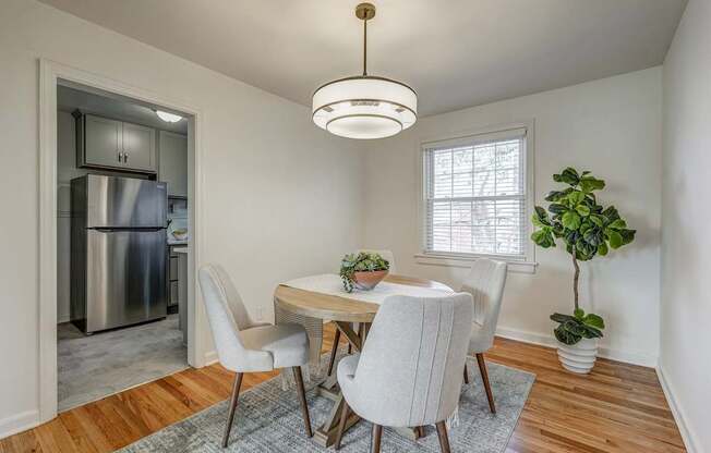 A dining room with a table and chairs.