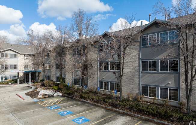 an apartment building with a parking lot in front of it