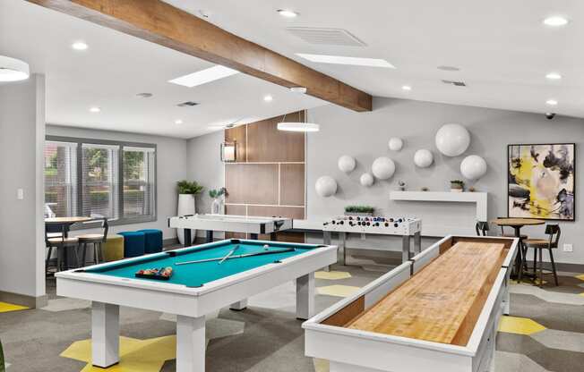 a game room with tables and ping pong