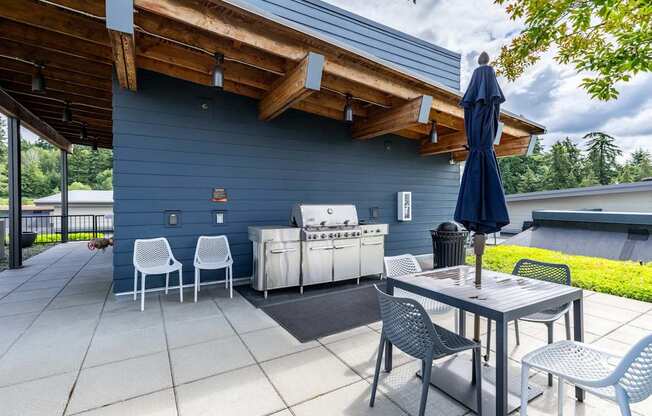 A blue patio with a table and chairs. at Kirkland Crossing Apartments, Washington