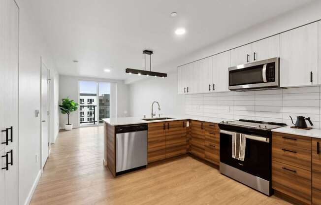 A modern kitchen with wooden cabinets and stainless steel appliances.