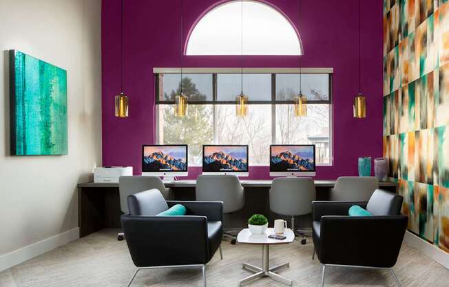 A room with purple walls and a large window with a view of trees.