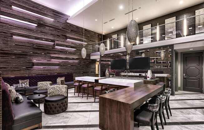 A modern kitchen with a dark wood finish and a long island with chairs.