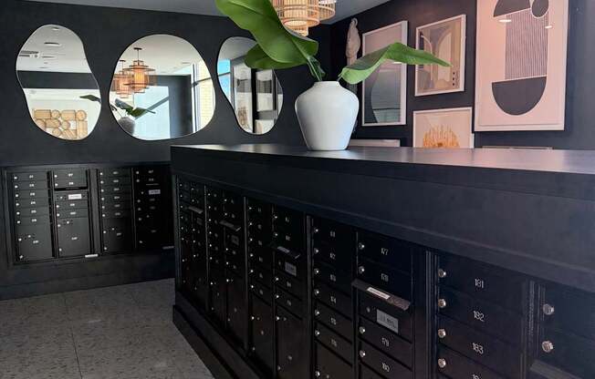 A wall with mirrors and a fan on it.