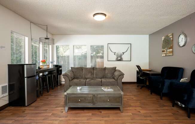 an open living room and dining room with a couch and a coffee table