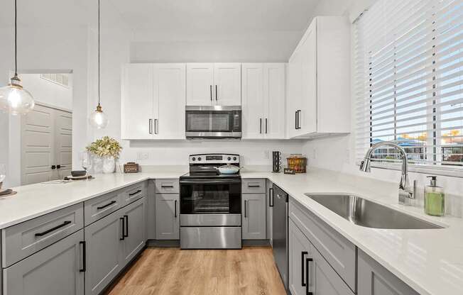 A modern kitchen with a stove top oven and a microwave above the stove.