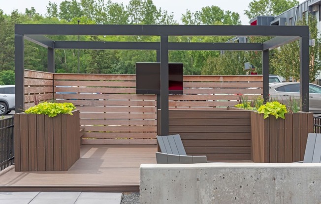 an outdoor entertaining area with a wooden privacy fence and a pergola