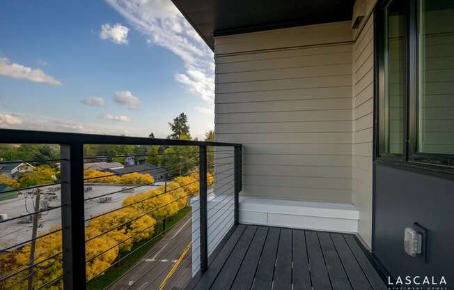 Spacious balcony with a view of Portland at LaScala Apartments in Beaverton, Oregon