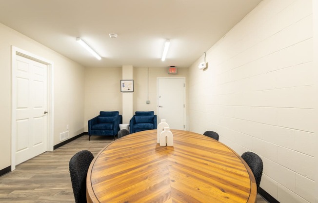 a conference room with a large wooden table and chairs