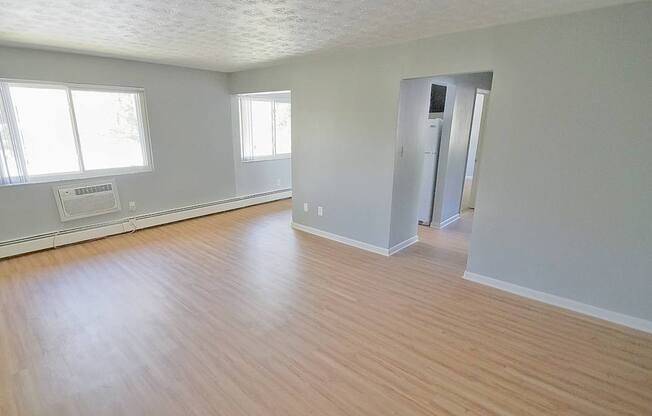 A room with wooden floors and white walls.