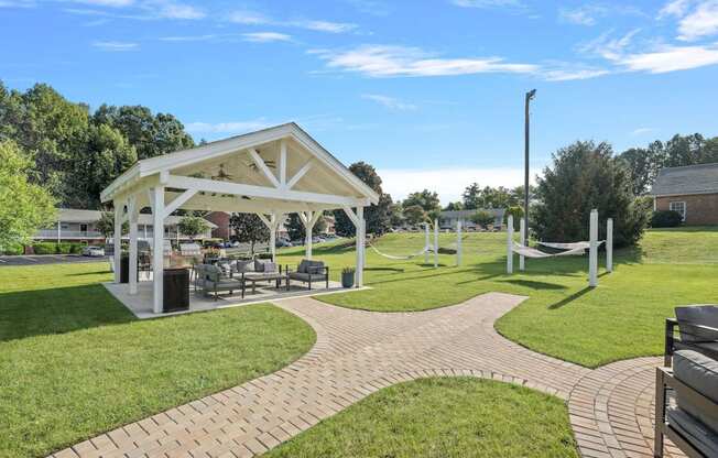 a picnic area with a pavilion and benches in a park