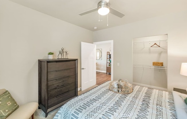 a bedroom with a large bed and a ceiling fanat Solace at Ballpark Village, Goodyear, Arizona