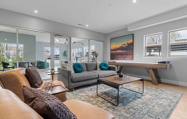 a living room with a couch coffee table and a ping pong table