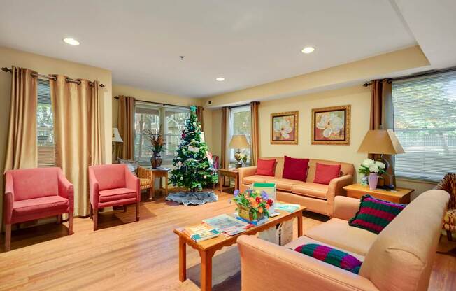 a living room filled with furniture and a christmas tree