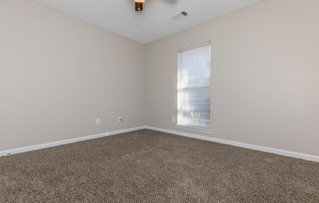a bedroom with a large window