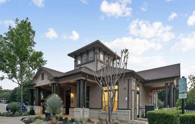 the front of a building with a clock on the side of it