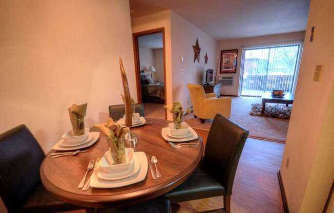 a dining room with a table and a living room