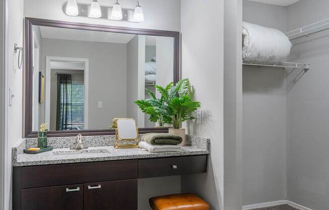 A bathroom with a vanity and a mirror.