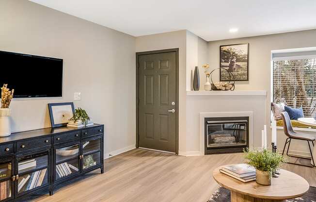 a living room with a fireplace and a tv