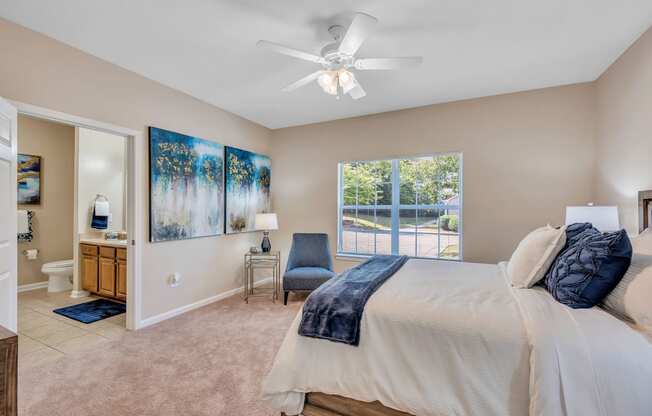 a bedroom with a large bed and a ceiling fan