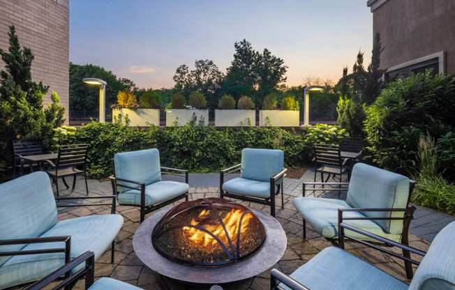 an outdoor patio with a fire pit and chairs at 15 Bank Apartments, White Plains, NY, New York, 10606