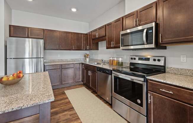 a kitchen with stainless steel appliances and granite counter tops