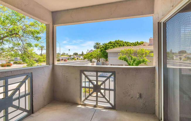 a balcony with a door and a view of the street