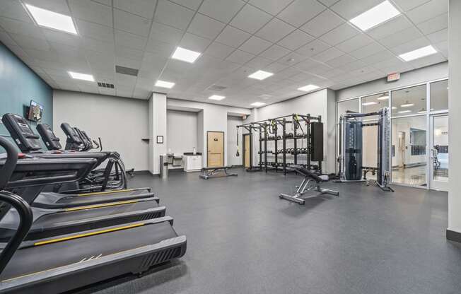 a large fitness room with treadmills and other exercise equipment  at The Icon, Richmond, VA, 23230