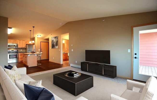 a living room with a couch and a tv. Fargo, ND Urban Plains Apartments