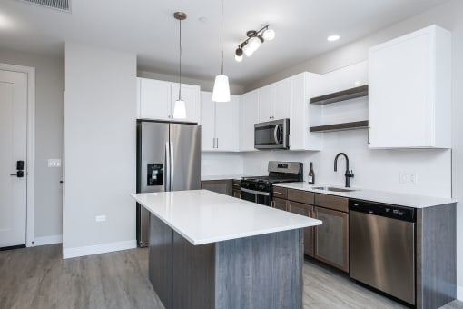 a kitchen with stainless steel appliances and a white counter top