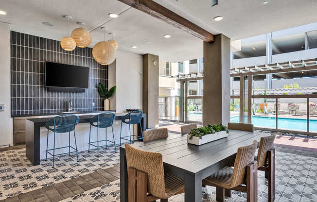 A modern dining room with a pool view.
