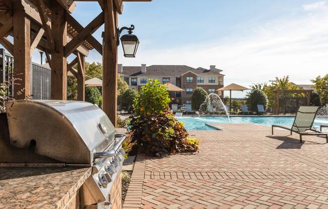 Courtyard with outdoor grill at Avenues at Craig Ranch apartments for rent