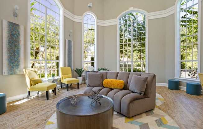 Community clubhouse seating area with couches and arm chairs at Hunters Green in Tampa, Florida.