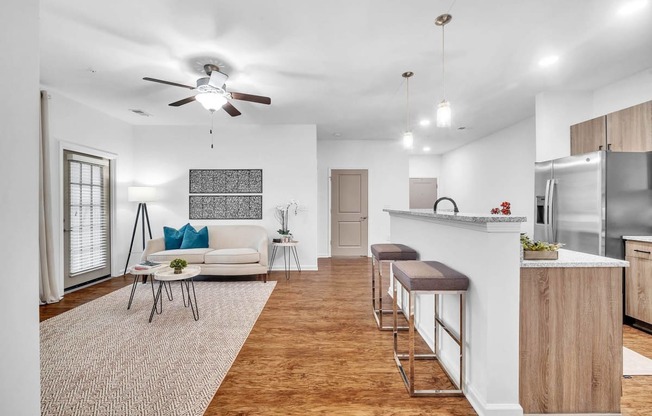 a kitchen and dining room with a wood floor and white walls