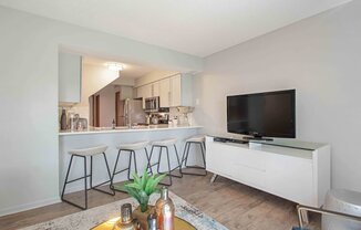 a living room with a bar and a television