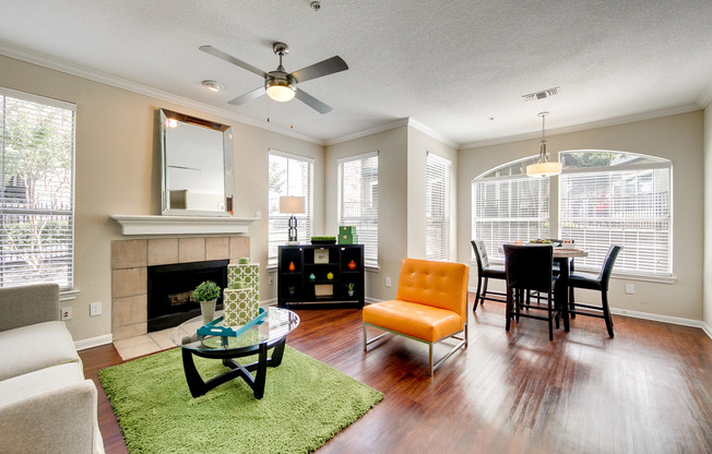 View of Upgraded Apartment Interior, Showing Living Room with Plank Wood Flooring and Fireplace at Stonebriar of Frisco Apartments