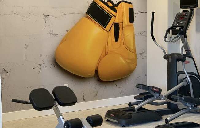 Fitness Center with Elliptical, Situp Station, and Giant Yellow Boxing Gloves Painted on the Wall