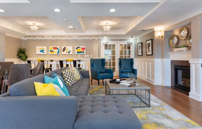 Resident Lounge with Sectional Sofa and Dual Chair Seating in Front of Fireplace | Canton Woods