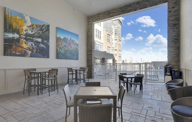A patio with a table and chairs and a view of a building.