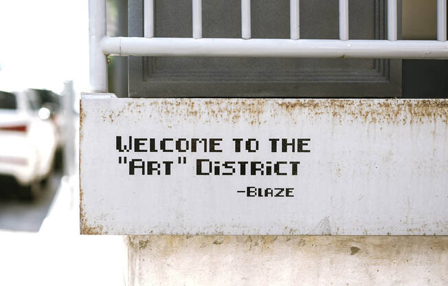 a sign on the side of a building that says welcome to the fifth district gate at The Lively, Jersey City New Jersey