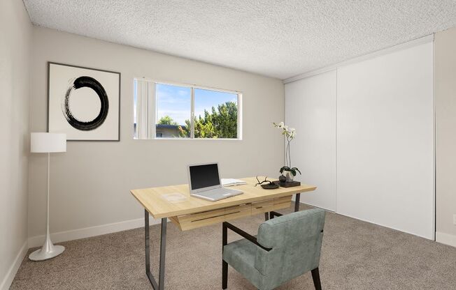 a home office with a laptop on a desk