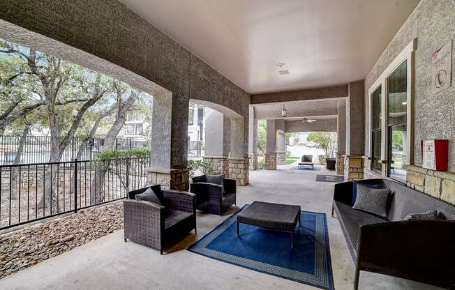 a large patio with furniture and a pool in the background