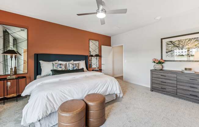 a bedroom with a bed and a ceiling fan