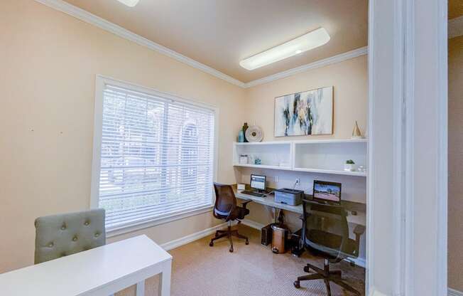 Community business center with computers and chairs.