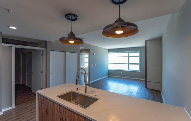 A kitchen with a sink and a window.