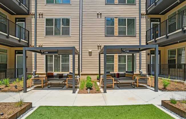 a patio with furniture in front of a building