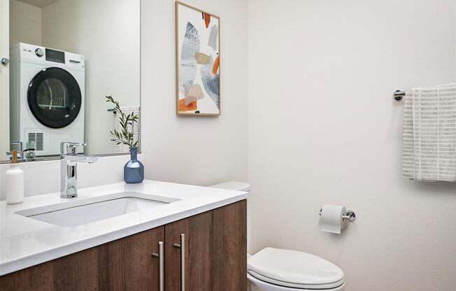 a bathroom with a sink and a toilet and a mirror