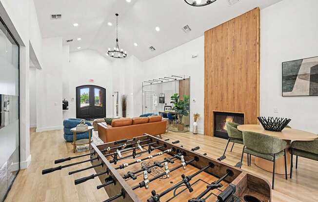A foosball table is in the middle of a living room.