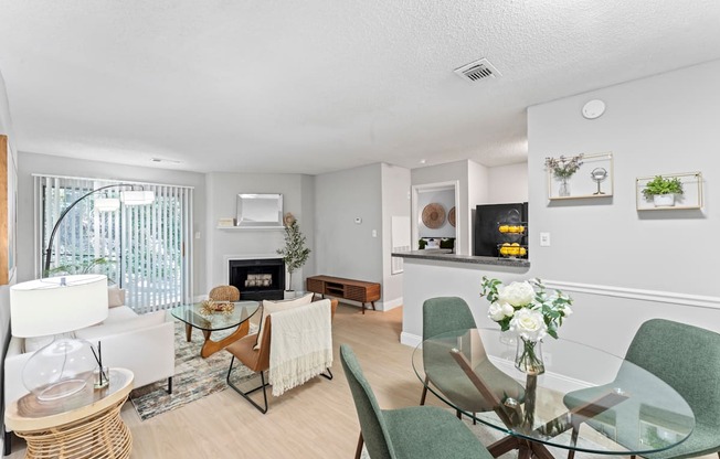 A modern living room with a glass table and chairs.