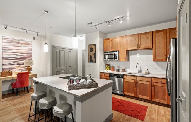 a kitchen with a large island and wooden cabinets